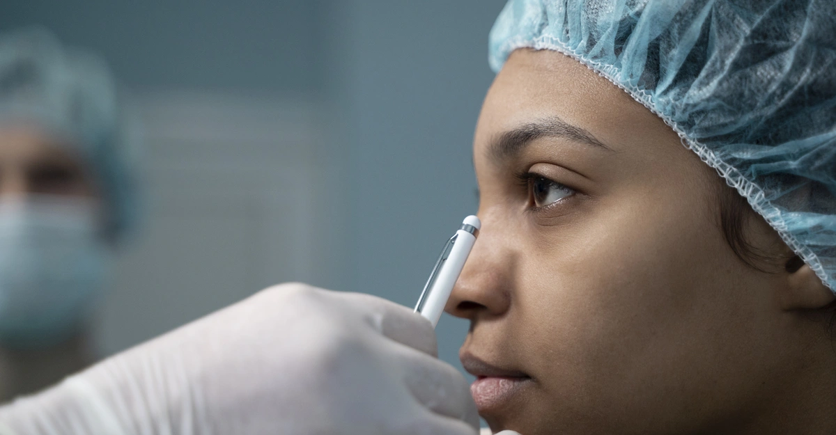Doctor inspecting the face of patient before cosmetic surgery